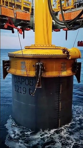 Installation of a monopile pillar for structural foundation.