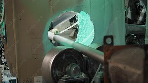 Metal tube manufacturing process at the industrial facility. Steel tube manufacturing process on the automated line. Equipment with a rolling mechanism making the tube in a manufacturing process