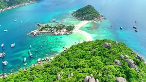 Escape to a tropical oasis, where crystalline waters lap against secluded shores, and a magical sandbar unveils nature's splendor. Flying from drone. Ocean background. Koh Tao, Thailand. 4K HDR.