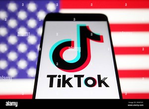 In this photo illustration, a TikTok Chinese video-sharing social networking service logo seen displayed on a smartphone with a flag of the United States in the background. (Photo by Pavlo Gonchar / SOPA Images/Sipa USA Stock Photo - Alamy