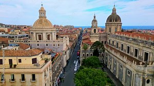 Catania, Sicily island, Italy. Drone aerial view 4k video, Europe ancient historical city center Duomo square, Cathedral of st. Agatha and elephant statue, travel Mediterranean seacoast port
