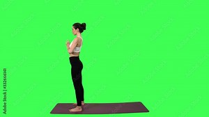 Extremely flexible woman practice a series of various positions, over green screen. Long shot.