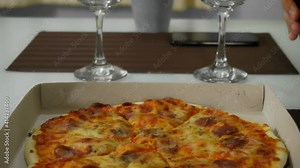 Young couple on a date at home with delivery pizza and red wine. 4k footage