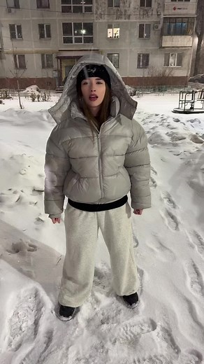 Person in Puffy Jacket in Snowy Outdoor Scene