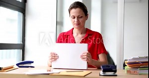 Beautiful woman in the office holding a stack of white sheets of paper. Workplace of an office employee and work with documentation Stock Video