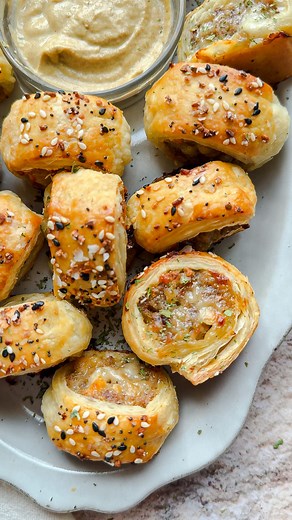 Laura Vitale on Instagram: "The best sausage rolls ever!!! So easy to make and best of all, can be assembled, cut and frozen until you need them and then all you have to do is add another 10ish minutes to the baking time and they are sensational! Full recipe below! 1/2 lb of Bulk Sausage (I used Jimmy Dean Sage Sausage but if using another kind, add about 1 tsp of ground sage to the mix) 1 Tbsp of Olive Oil 1/2 of a Yellow Onion, finely chopped 1/4 tsp of Salt 1/3 cup of Shredded Sharp Cheddar 3