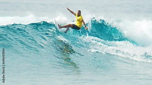 Surfer rides the wave in the ocean. Sultans surf break near the island on Huraa in the Maldives