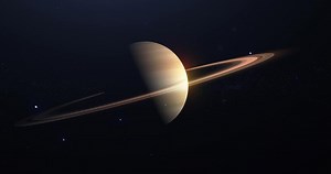 saturn in the night sky with stars