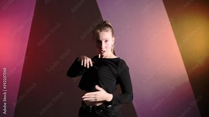 Medium long shot of young plastic woman dancing contemporary freestyle dance in a choreographic studio