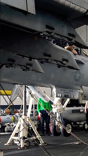 Maintenance on the wheels of an F/A-18F Super Hornet fighter jet