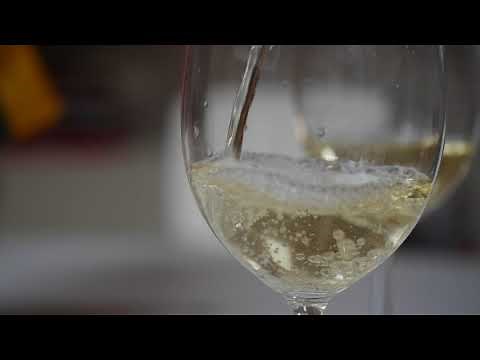 White wine pouring into a glass. Free HD slow motion video footage