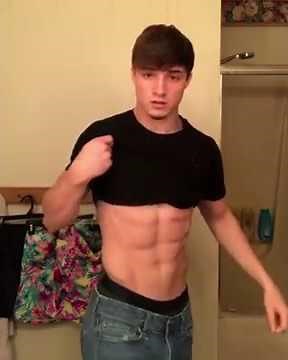 Teen muscle Josh flexing with his shirt on and revealing his hard, well defined abs