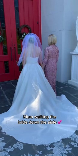 Mother Walking Daughter Down Aisle at Wedding