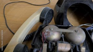 Internal parts of old rotary phone 1950s, 1960s. Camera flying over phone