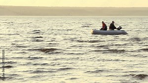 Two mans fishing together in a boat