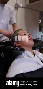 Skilled hairdresser carefully washing clients hair with water in slow motion, demonstrating professional hair care service inside modern beauty salon Stock Video Footage - Alamy