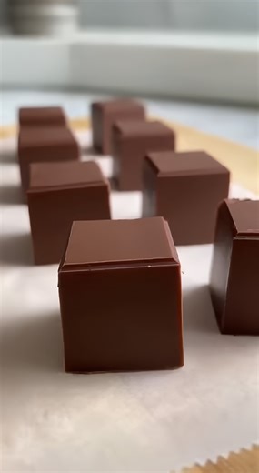 Indulge in the ultimate high-energy treat with this silky, decadent Coffee Fudge that combines rich dark chocolate with a bold espresso kick! ☕️🍫🔥 🛒 Ingredients : 3 cups (510g) Semi-sweet or Dark Chocolate Chips 14 ounces (397g) Sweetened Condensed Milk 2 tablespoons (30ml) Strongly brewed Espresso 1 teaspoon Vanilla Extract 1/2 teaspoon Sea salt 👩‍🍳 Easy Steps : 🥣 Combine and Melt - Line an 8x8 inch baking pan with parchment paper, leaving a slight overhang on the sides for easy removal. 