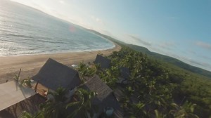 Dynamic drone tour of a sunny beach - Free Stock Video