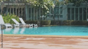 Little girl coming to the swimming pool and jumping into water in slow motion