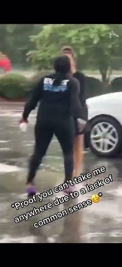 Two women fighting in a parking lot while break dancing