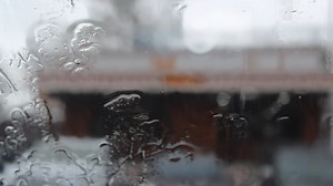 Download close-up of raindrops on a window pane.  blurred background. for free