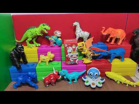 Open the box containing a lion dance toy, along with battery-operated animals: a gorilla, a walki...