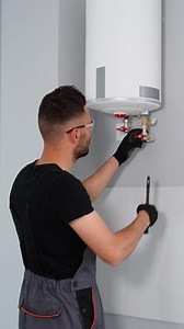 Professional heating master installs boiler. Vertical