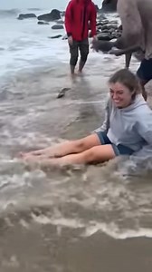 Woman relaxing by the water gets blindsided when a huge snake explodes out and grabs her legs! | AtlasAnimal