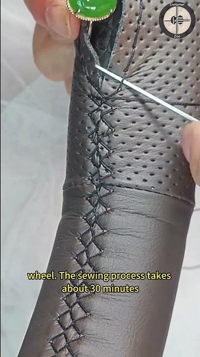 Hand sewn steering wheel cover on the car steering wheel. The sewing process takes about 30 minutes