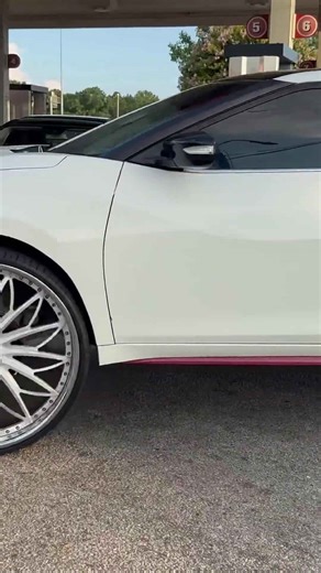 White Nissan Maxima on 28’s Rucci riding