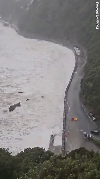 Huge waves crash over cars on Devon coast as weather warnings issued