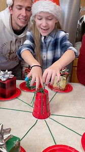 8.1K views · 497 reactions | the Present String Pull Game  Kids, Dad, and family play festive table game with presents and strings. Funny Christmas gift game for family gatherings or Holiday parties. This video was produced by Benson Family, Network Media, and Benson Bros. (for entertainment purposes only) | Aaron’s Family | Facebook