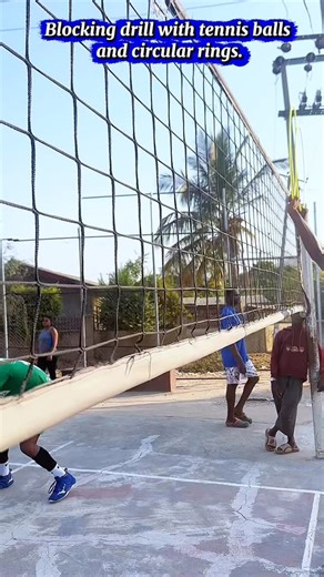 Blocking Drill Using Tennis Balls and Circular Rings This drill helps players improve their blocking technique, hand positioning, and reaction speed. Place circular rings on the floor to mark where the blocker should land after the jump. A coach or partner tosses tennis balls over the net, and the blocker focuses on reading the toss, jumping on time, and directing their hands over the net. The rings help guide correct footwork and landing position, while the tennis balls train quick reaction and