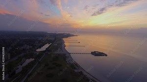Aerial shot of Malmo beach Ribersborg and the piers with kallbadhuset and the bridge Bron in the background in 4k
