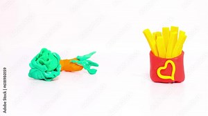 Plasticine stop motion animation. Fries, hamburgers and hot dogs turn into healthy carrots, cabbage and corn. The concept of choosing between healthy and unhealthy food Stock Video