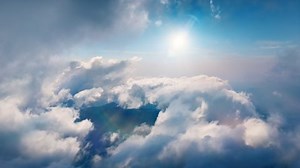 Flying through heavenly beautiful sunny cloudscape. Amazing timelapse of white fluffy clouds moving softly on the sky and the sun shining above the clouds with beautiful rays and lens flare.