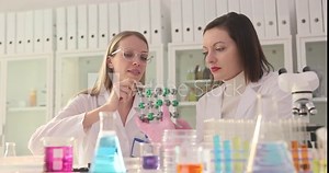 Two scientists work together in a laboratory and study the structure of a molecule Stock Video