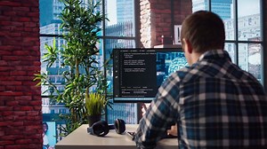 Developer writing code on computer and doing maintenance on artificial intelligence neural networks computerized model. Tech support expert typing on keyboard, doing checkup on AI systems, camera A