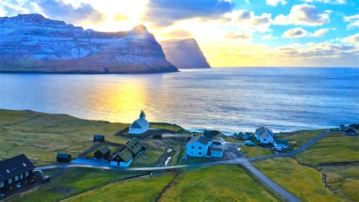 Turf roofed houses beneath cliffs in the Faroe Islands