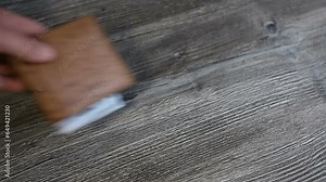 A man puts a wallet with money on the table. The man takes his wallet from the table. Looping endless video.