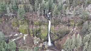 Horsetail falls flows over the rugged, mountainous landscape in the Columbia River Gorge separating the states of Oregon and Washington. The Pacific Northwest region has incredible outdoor scenery.