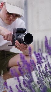 Vertical shot of photographer test variable ND filter near lavender shrub