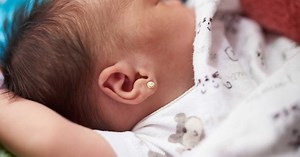 Dad furiously removes earrings from baby's ears after wife secretly pierces them