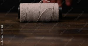 white cotton thread wound on a tube , thin cotton thread for use in cooking Stock Video