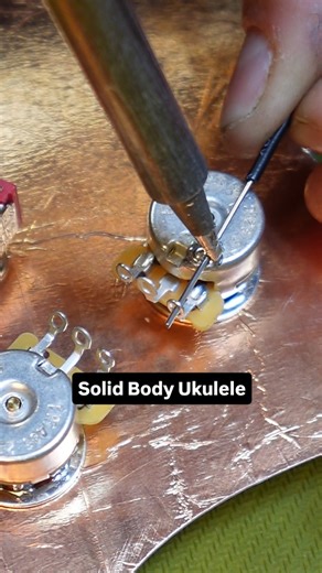 Emerson on Instagram: "I have been working on this solid body electric baritone ukulele for my girlfriend for the last few weeks and I am taking a break from building the body to make and wire up the pickguard. I started by making a template for the guard. I am using a PVC material, which means that unless I want to create a poison that will damage both me and my machine, I can’t cut the pickguard directly. As I am sure you can tell from the guard, I am making a Stratocaster shaped uke based on