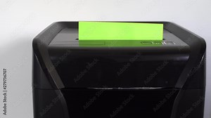 Businessman putting classified information and documents into a new paper shredding machine in office