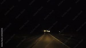 Driving On Road At Night With Oncoming Traffic Bright Headlights And Roundabout Traffic Signs Stock Video