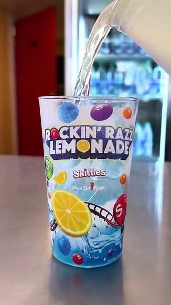 Don’t miss out on this rainbow explosion of flavor! Our Rockin’ Razz Lemonade made with Skittles is taking over for a wild and tasty limited time! Stop by Thirsty Buffalo, Funnelliscious or Cocktails on the Corner today to get yours 😝 | Six Flags Fiesta Texas
