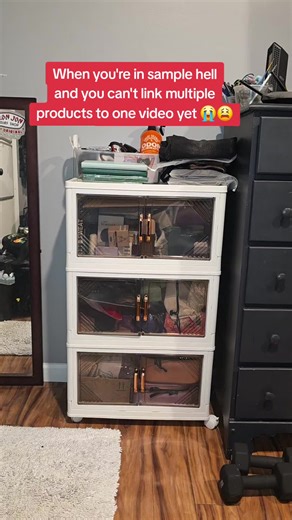 Everything inside of that three tier cabinet is all tiktok shop samples... including the cabinet. I have a big bin in the living room I haven't brought in my room that doesn't fit inside those cabinets, so I need more cabinets right? i must have fifteen samples to review at all times and it never slows down. come on, tiktok, tell me what I need to link multiple products to one video! please! #viral #tiktokshop #showcase #tiktokaffiliate #samplehell