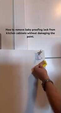 How to remove/clean adhesive baby proofing lock from kitchen cabinets without damaging the paint.